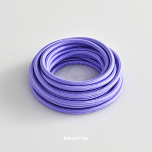 A roll of solid round lavender fabric cord 4.88m (16ft) on a white background