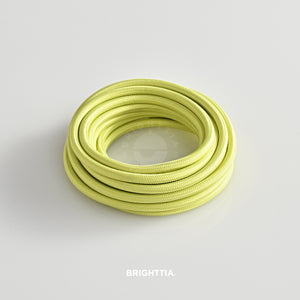 A roll of solid round pale yellow fabric cord 4.88m (16ft) on a white background