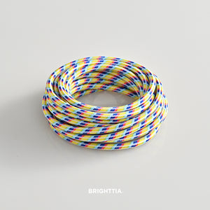 A roll of solid round rainbow fabric cord 4.88m (16ft) on a white background