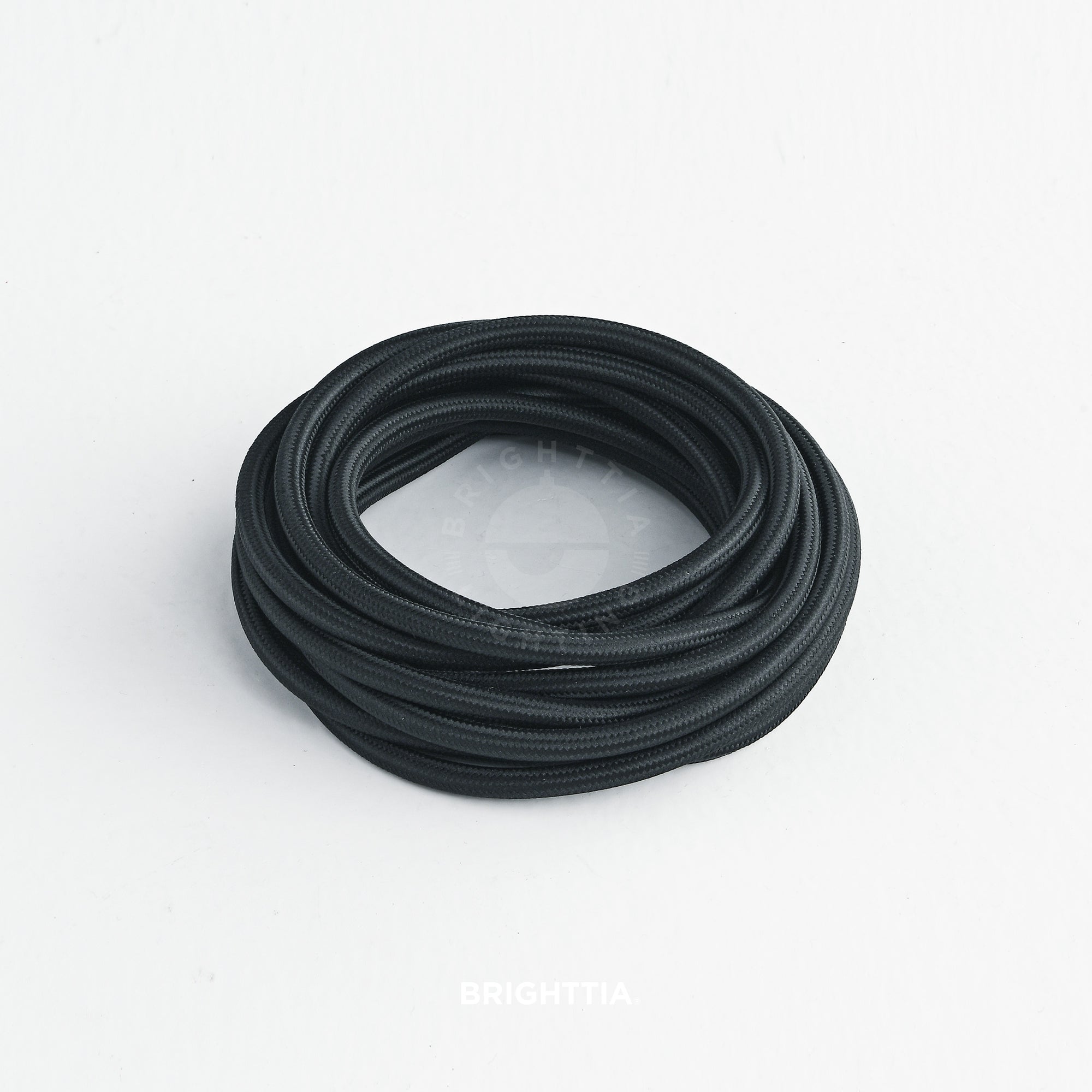 A roll of solid round black fabric cord on white background