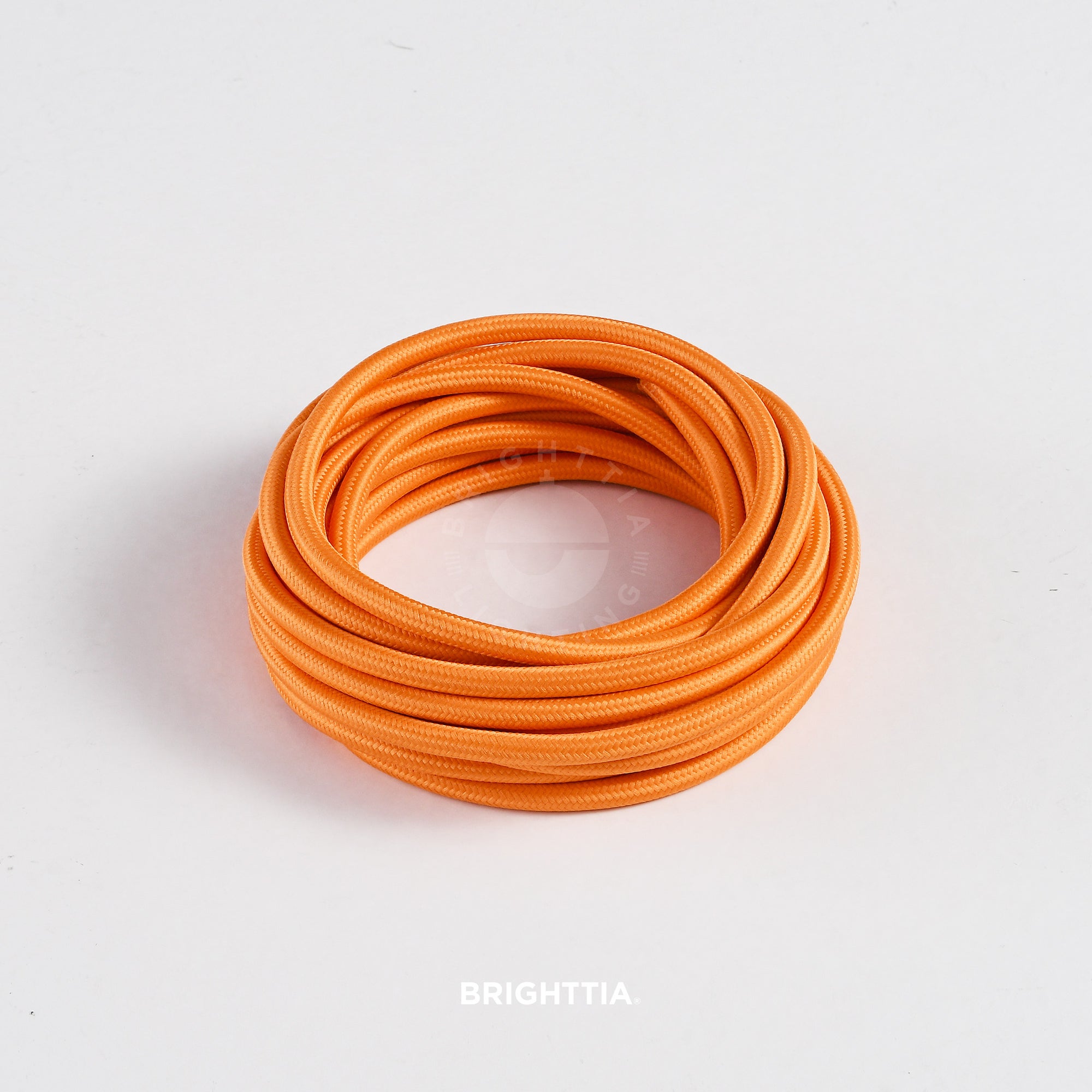 A roll of solid round orange fabric cord 4.88m (16ft) on a white background