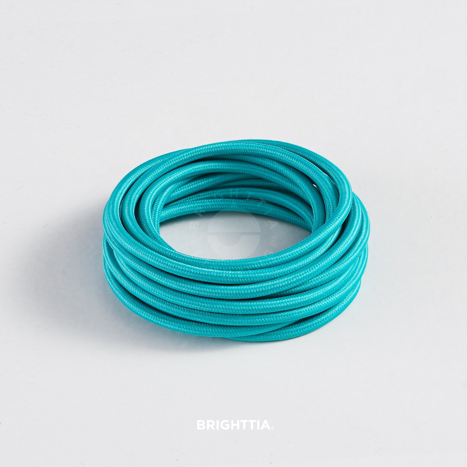 A roll of solid round turquoise fabric cord 4.88m (16ft) on a white background
