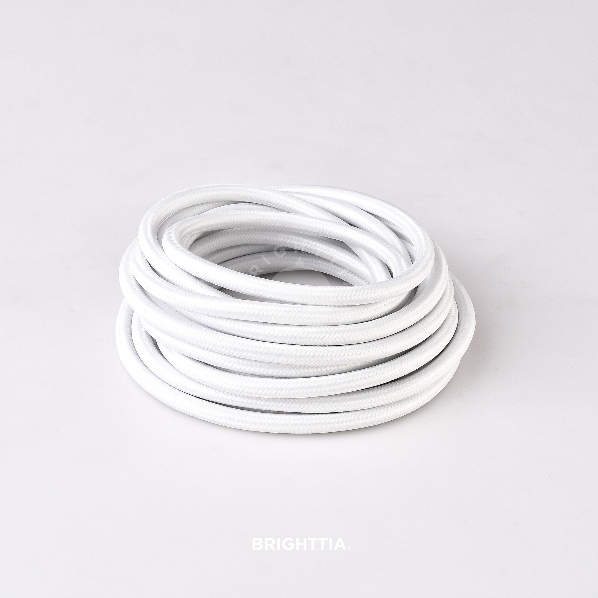 A roll of solid round white fabric cord 4.88m (16ft) on a white background