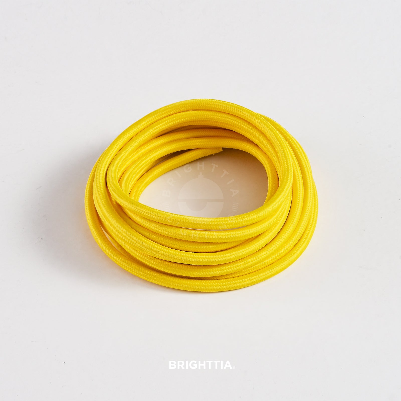 A roll of solid round yellow fabric cord 4.88m (16ft) on a white background