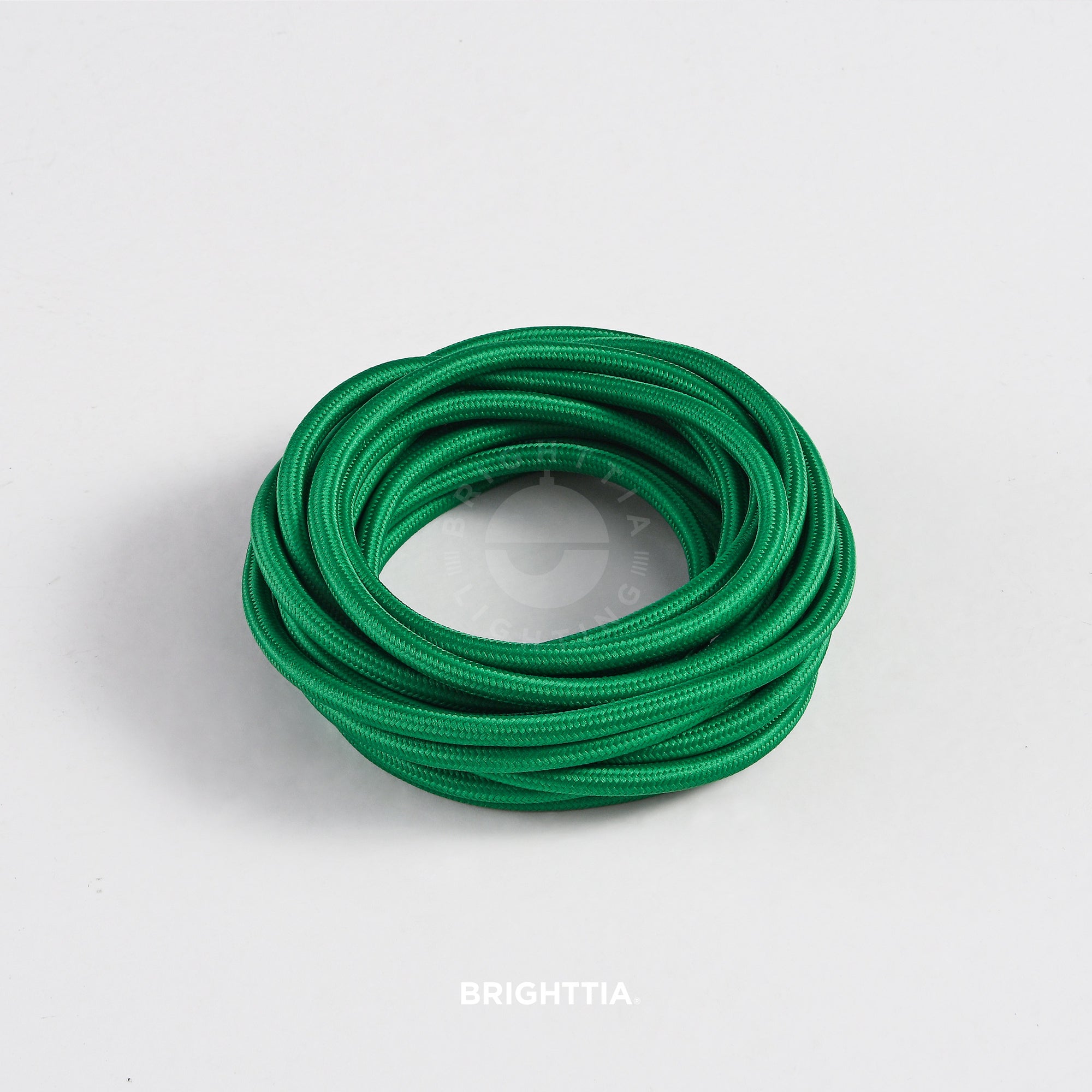 A roll of solid round forest green fabric cord 4.88m (16ft) on a white background