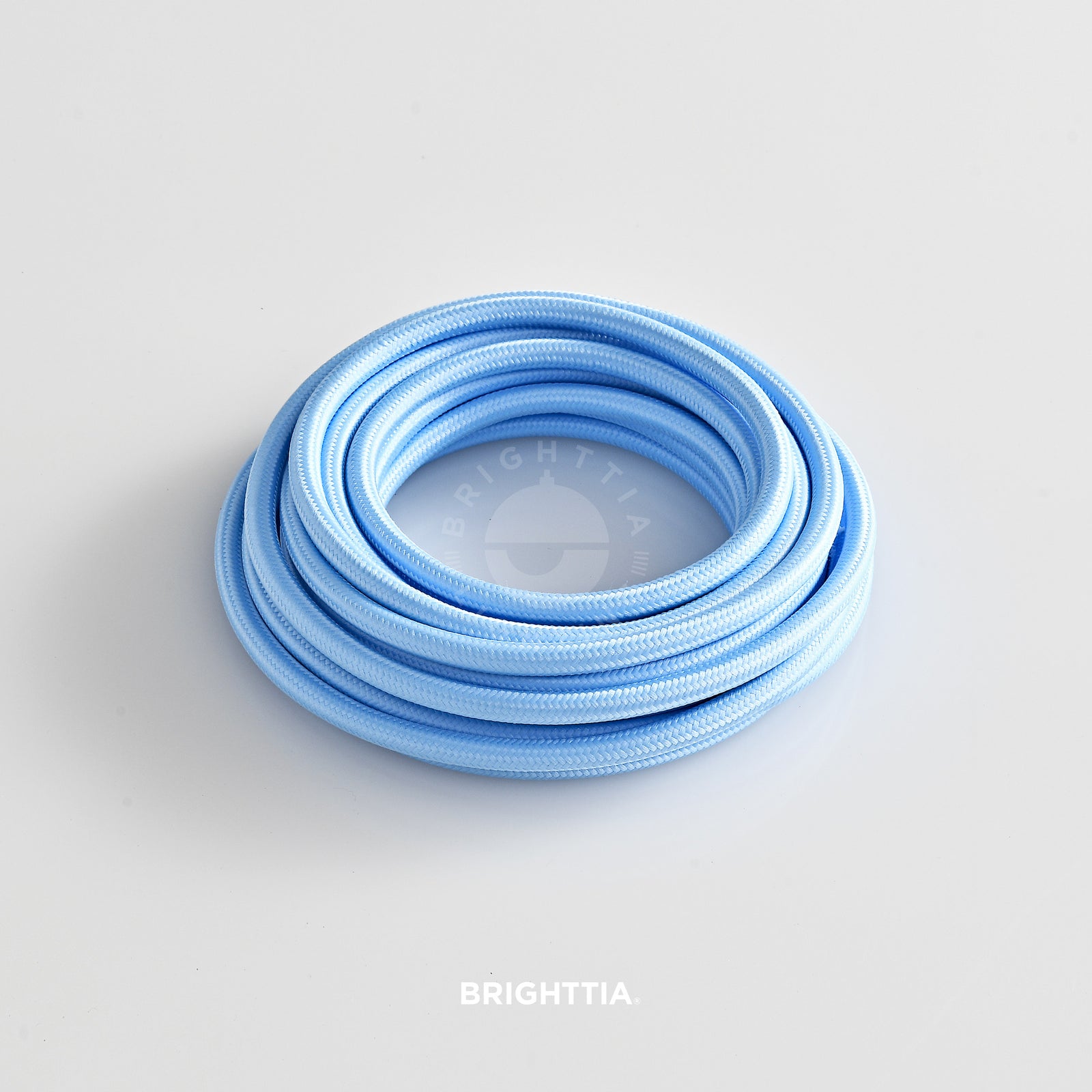 A roll of solid round light blue fabric cord 4.88m (16ft) on a white background