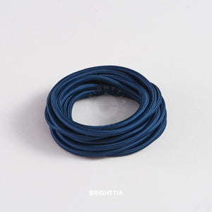 A roll of solid round midnight blue fabric cord 4.88m (16ft) on a white background