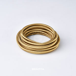 A roll of solid round brass fabric cord 4.88m (16ft) on a white background